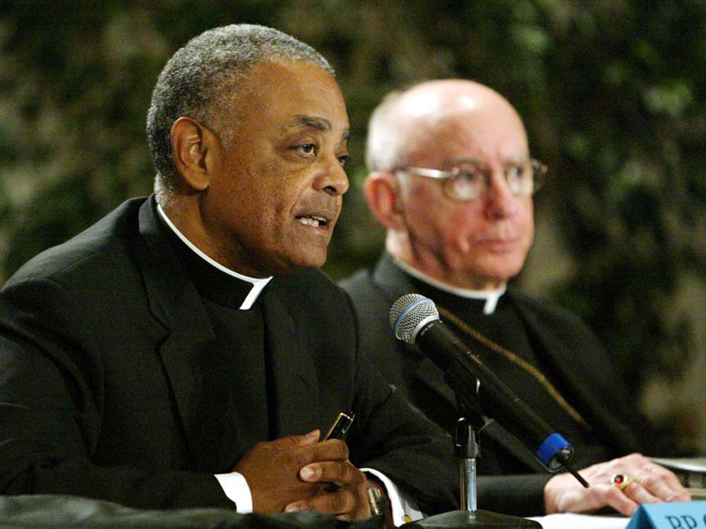 Archbishop Harry Flynn (right) joins Bishop Wilton Gregory to present a report on sexual abuse to the U.S. Conference of Catholic Bishops in June 2003.